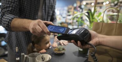 close up father and daughter paying with smart phone contactless payment at plant shop counter 697537221 5b2d60593037130036fa61c0