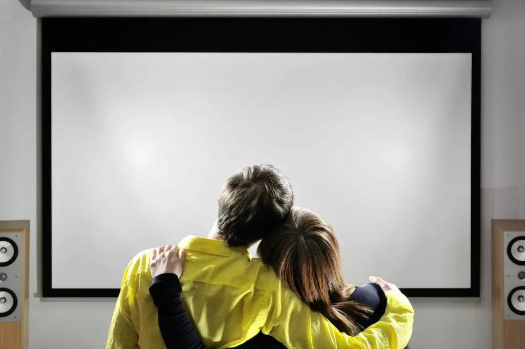 couple looking at projector screen GettyImages 157503674 5c22baa646e0fb00017b68b9