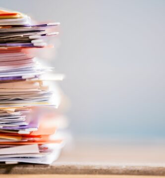 large stack of files paperwork close up desk office nobody 519557623 5aa4d23243a10300362a6299