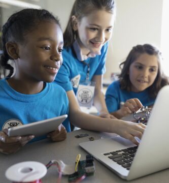 pre adolescent girls programming electronics at laptop and digital tablet in classroom 705002083 5b439a9f46e0fb00379c8bf9