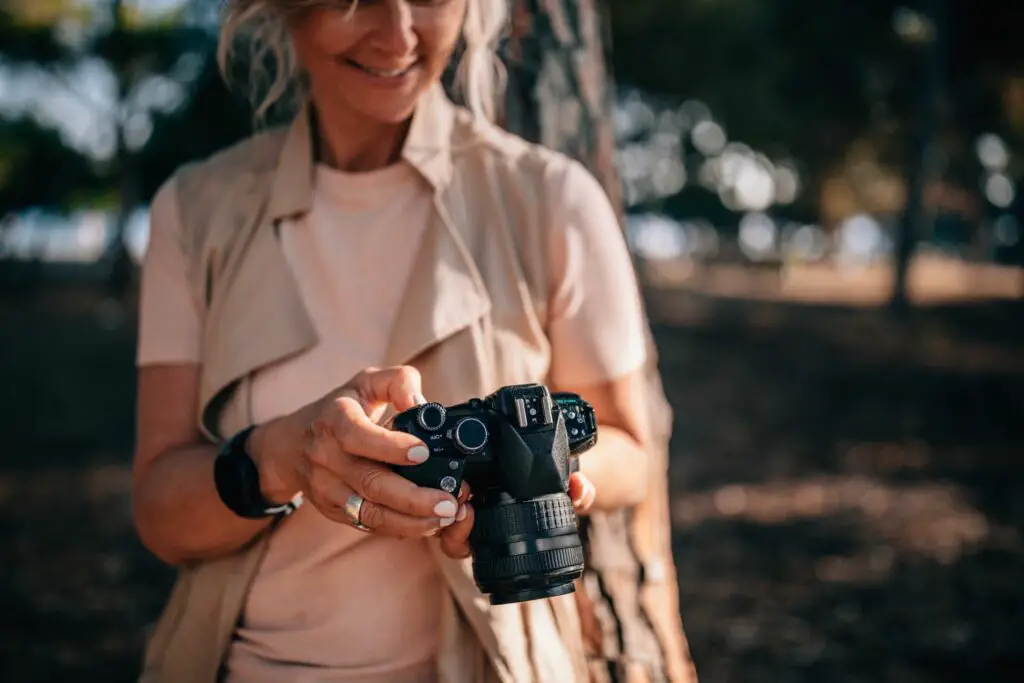 senior woman using camera and looking at photos in nature 979294778 5c0a9ea6c9e77c0001eb82a6