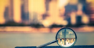 the bund of shanghai reflected in a magnifying glass 657283468 5a2f09be98020700374eaa1b