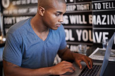 Man met laptop in café