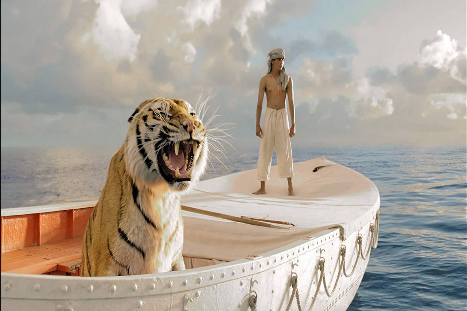 Een screenshot van een scène uit de film Life of Pi.  De scène bevat de hoofdpersoon Pi Patel en een tijger genaamd Richard Parker.