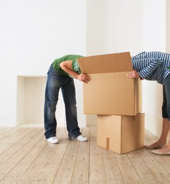 1889405 Young couple unpacking box in new home with faces hidden 58c921513df78c353c69939b