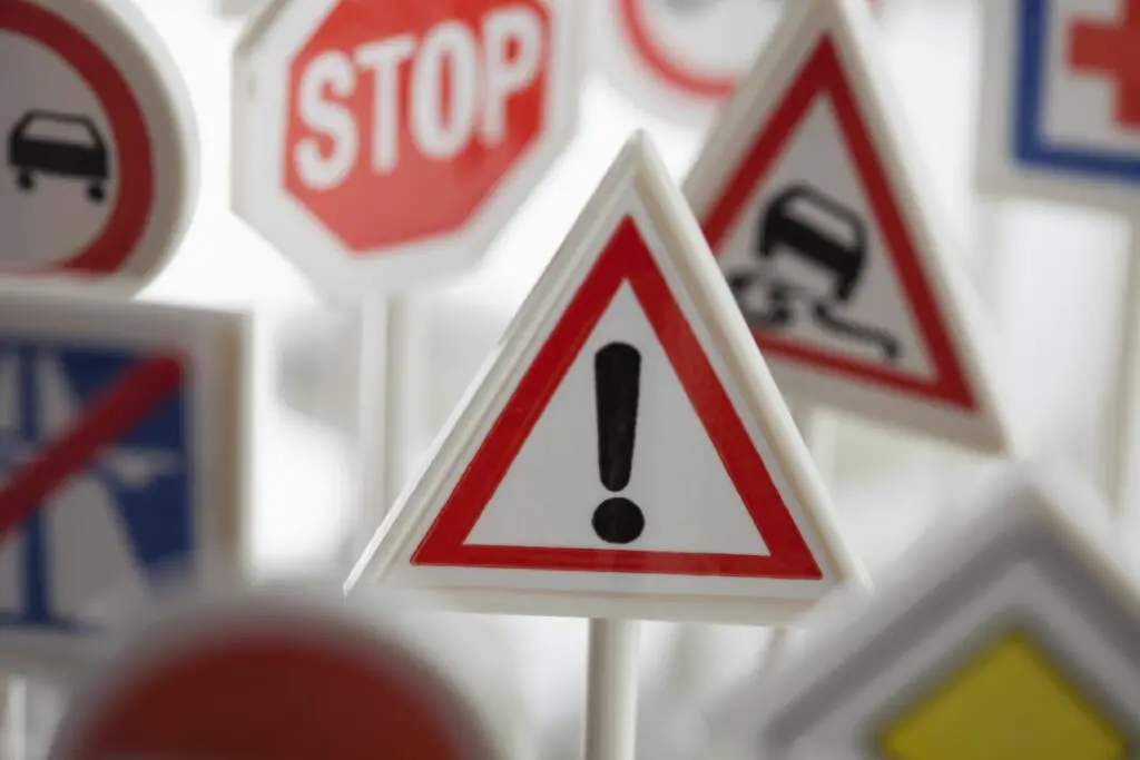a toy hazard sign surrounded by other various road warning signs 450741917 593c61b83df78c537b475bc2