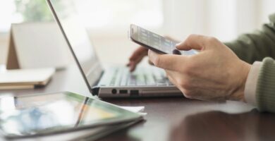 close up of mans hands working at desk with electronic devices 555173169 573f138a5f9b58723de8bfe1