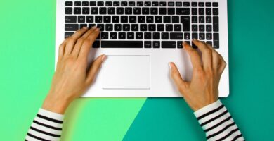 cropped hands of woman using laptop over colored background 1053740888 5c39561c46e0fb000173aa26