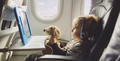 little boy sitting on an airplane watching something on digital tablet 588493599 5c3ab05246e0fb00015be86f