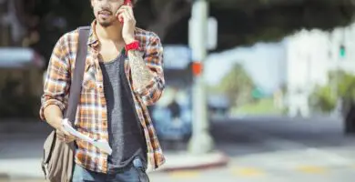 man talking on cell phone in urban crosswalk 483605653 57c44cd65f9b5855e58eea18