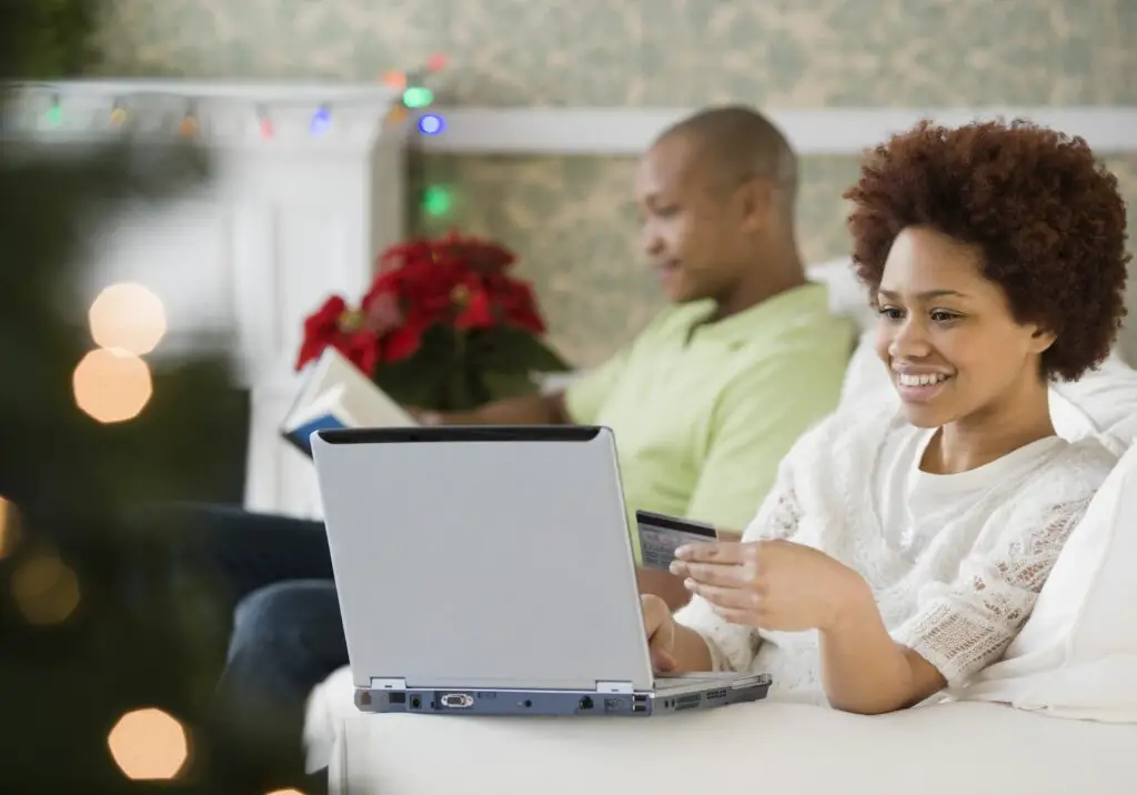 mixed race woman buying christmas presents online with credit card 84527986 582352235f9b58d5b1ea09cc