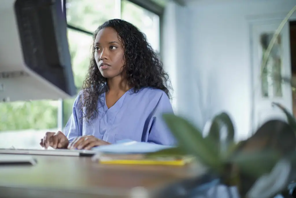 mixed race woman typing on computer 114849804 574a210e5f9b5851653146b9