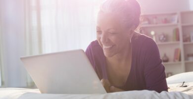 older hispanic woman using laptop on bed 546825877 59bdb77ac4124400106d23cd