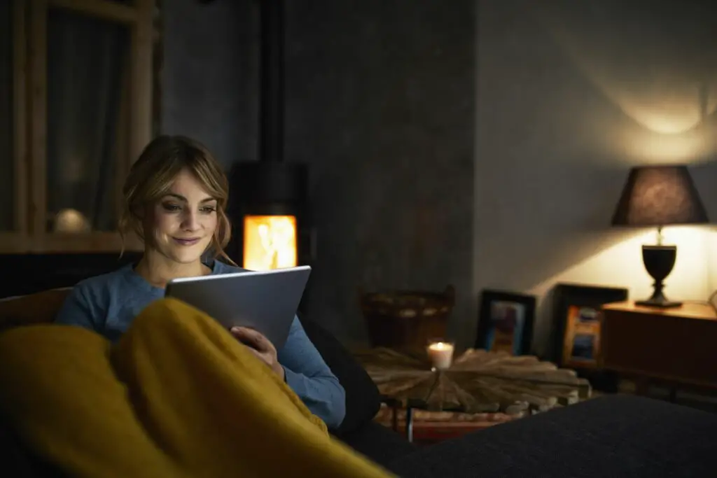 portrait of smiling woman with tablet relaxing on couch in the evening 919443026 5c0964a746e0fb00011af583