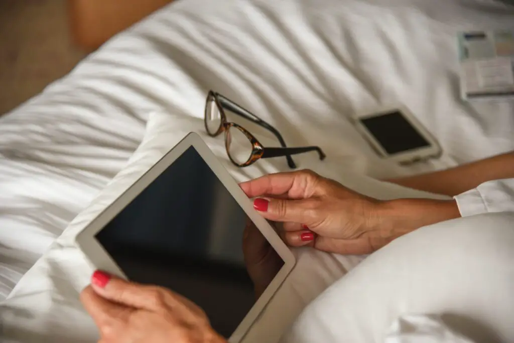 woman using digital tablet on bed 760250981 5b8460bec9e77c005744bba4