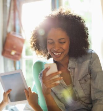 women using tablet computer and cell phone in bedroom 175139715 59a5ebe2aad52b0011674b12