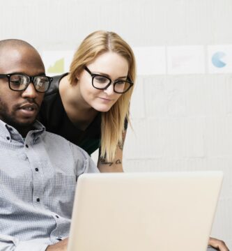 young business partners looking at computer in design office 476846211 584572c35f9b5851e5302c4e