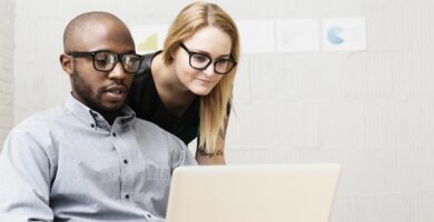 young business partners looking at computer in design office 476846211 584572c35f9b5851e5302c4e