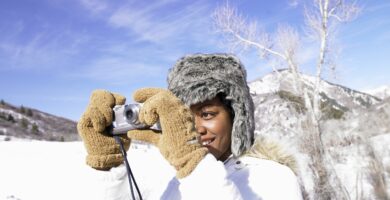 young woman in warm clothing in snow taking photo with digital camera 200556215 001 5b1fd9d004d1cf003c455029