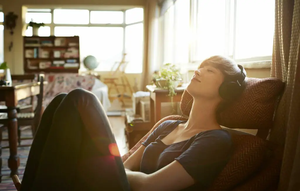 young woman relaxing with headphones at home 496125821 c1c6d1855bb04235a1fc50730fe62842