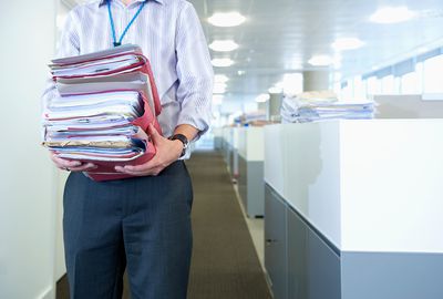 Person carrying paperwork in office