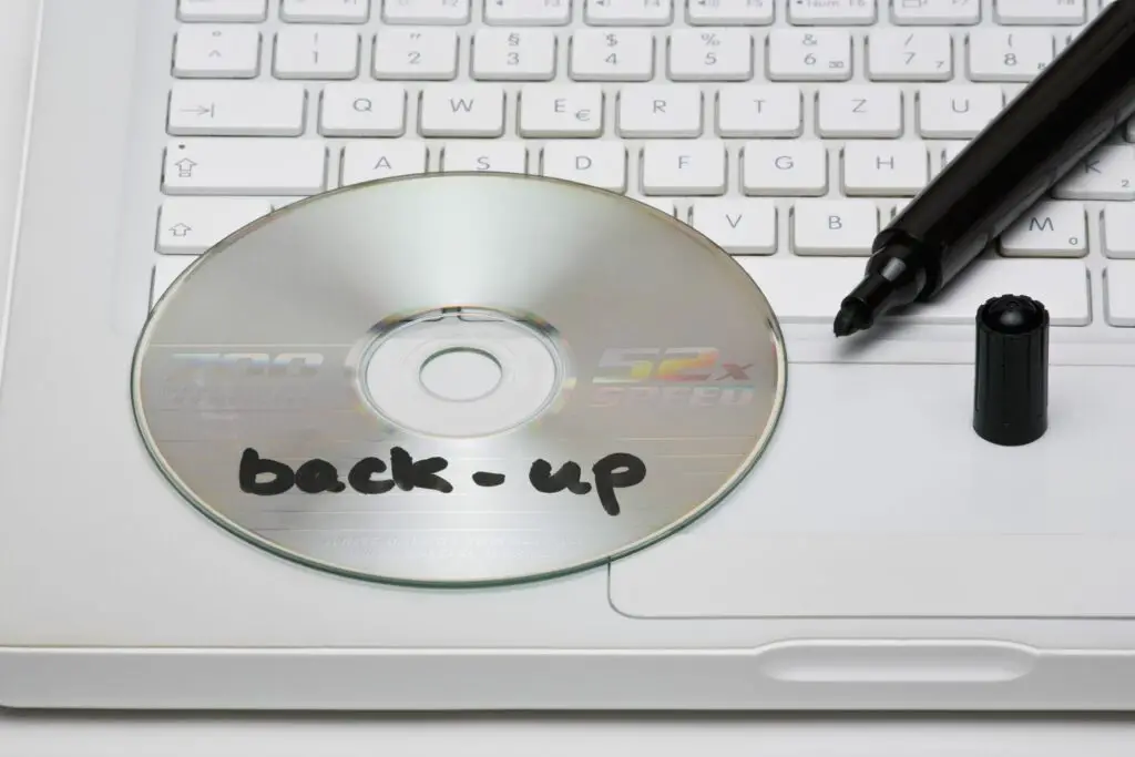 detail of a back up disc and a marker on a laptop 101883221 5bfae89946e0fb005188698c