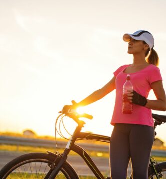 Woman with bicycle on road what to know about insurance coverage 58b61b293df78cdcd84de9e8